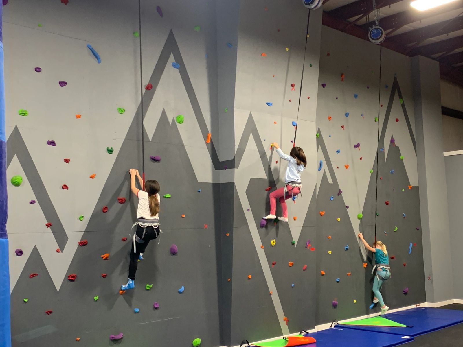 Two kids climbing the indoor climbing wall