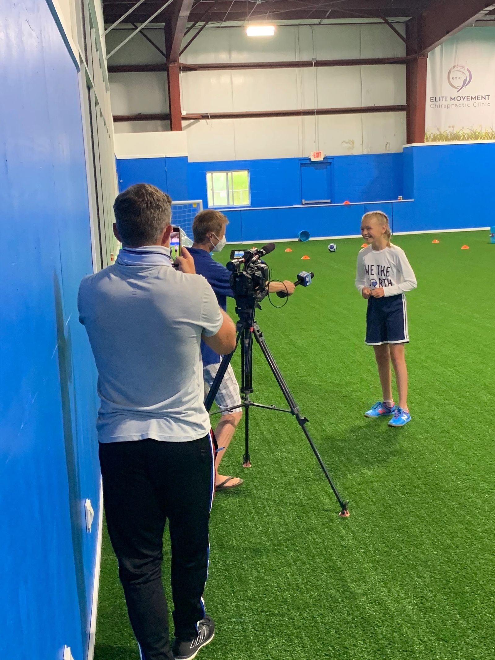 A young girl on the indoor turf field
